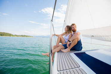 Young couple sailing on Chiemsee lake, Bavaria, Germany - CUF49610