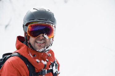 Male skier in ski helmet and goggles with frosty beard, portrait, Alpe-d'Huez, Rhone-Alpes, France - CUF49650