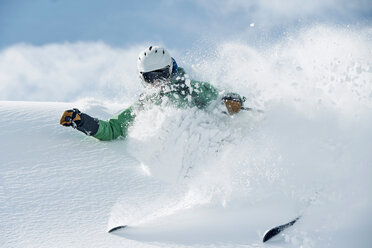 Male skier speeding down snow covered mountain, Alpe-d'Huez, Rhone-Alpes, France - CUF49658