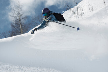 Male skier skiing on powder snow, Alpe-d'Huez, Rhone-Alpes, France - CUF49663