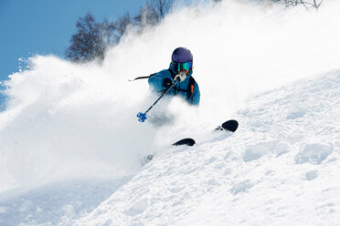 Male skier swerve skiing down mountain, Alpe-d'Huez, Rhone-Alpes, France - CUF49695