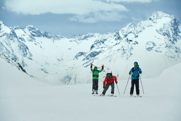 Landscape with three male skiers, portrait, Alpe-d'Huez, Rhone-Alpes, France - CUF49713