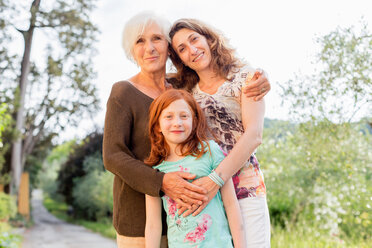 Girl on rural road with mother and grandmother, portrait - ISF21044