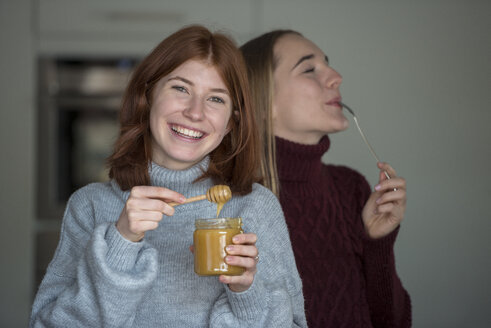 Zwei beste Freunde probieren Honig in der Küche - LBF02419