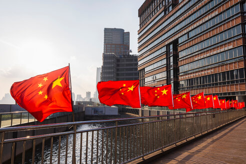 Row of Chinese flags on Huangpu river promenade, Shanghai, China - CUF49816