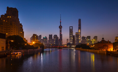Waibaidu bridge over Huangpu river with Pudong skyline at night, Shanghai, China stock photo