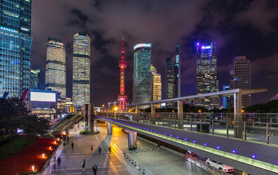 Pudong skyline with Oriental Pearl Tower and elevated walkway at night, Shanghai, China - CUF49849