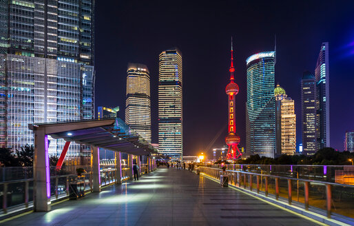 Pudong skyline with Oriental Pearl Tower from elevated walkway at night, Shanghai, China - CUF49853