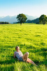 Frau im Gras liegend in der Landschaft, Sonthofen, Bayern, Deutschland - CUF49902