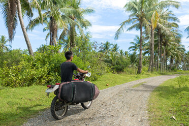 Motorcyclist with surfboard, Abulug, Cagayan, Philippines - CUF49917