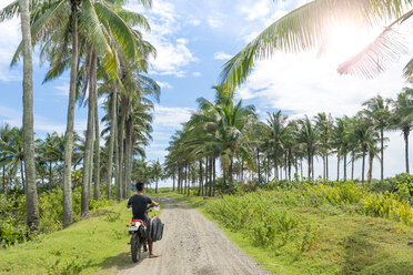 Motorcyclist with surfboard, Abulug, Cagayan, Philippines - CUF49918