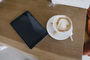 Digital tablet on desk with cup of cappuccino with - JOSF03172