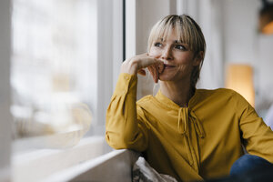 Portrait of a beautiful blond woman, looking out of window - JOSF03191