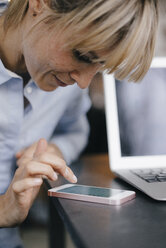 Smiling businesswoman using smartphone - JOSF03193