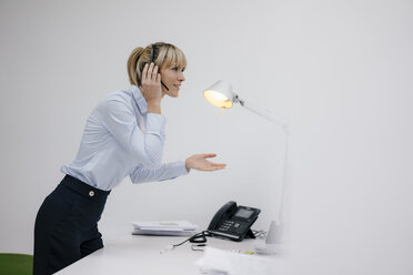 Businesswoman having a conference call with headset - JOSF03209