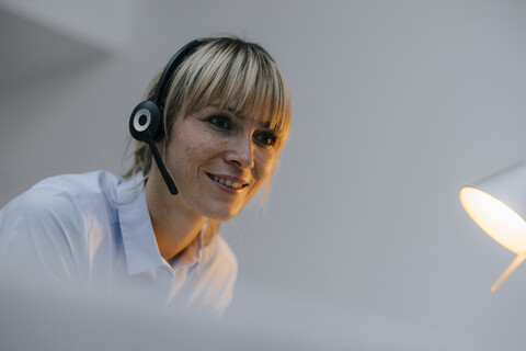 Businesswoman having a conference call with headset stock photo