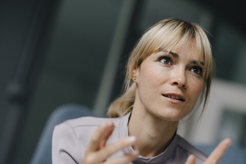 Portrait of a blond businesswoman, talking passionately stock photo