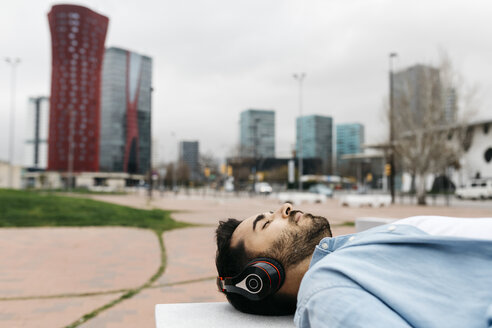 Mann macht eine Pause in der Stadt und hört Musik - JRFF02849
