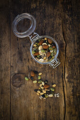 Preserving jar of roasted soy beans, seeds and nuts on wood - LVF07877