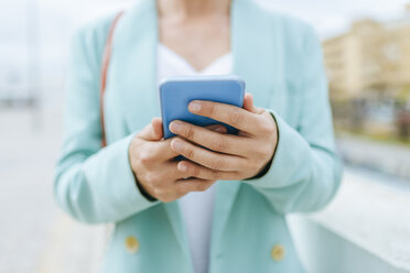 Close-up of woman's hands with smartphone - KIJF02420