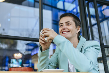 Woman dressed in a jacket with a coffee cup - KIJF02444