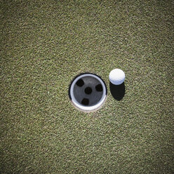 Golf Ball Next to a Putting Cup - MINF10874