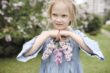 Portrait of smiling girl with lilac blossoms - EYAF00010