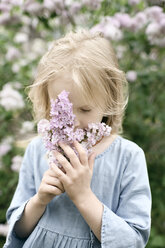 Portrait of smiling girl with lilac blossoms, sniffing - EYAF00012