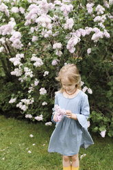 Portrait of smiling girl with lilac blossoms - EYAF00013