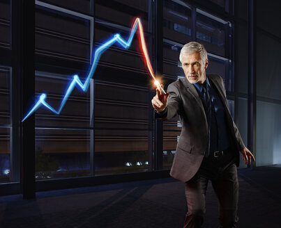 Businessman painting the stock market development with light - RORF01789
