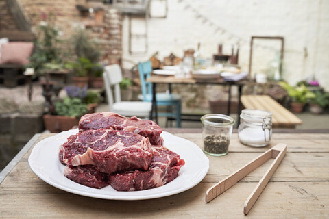 Barbecue in a backyard, steaks on a plate stock photo