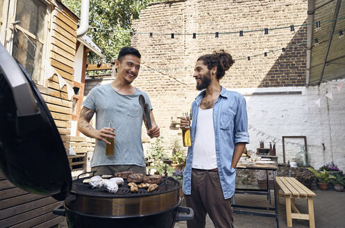 Friends preparing meat for a barbecue in the backyard - PDF01808