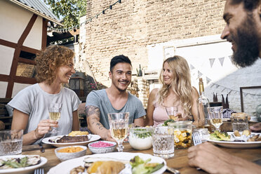 Friends having fun at a barbecue party, eating together - PDF01850