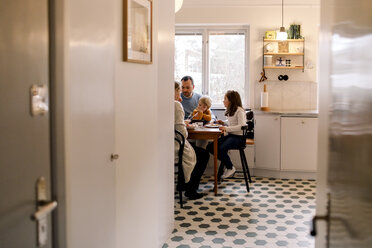 Family having meal together in kitchen at home - MASF11608