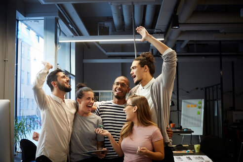 Male and female entrepreneurs cheering in creative office - MASF11705