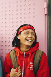 Cheerful young man looking away against wall - MASF11780