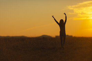 Woman walking in nature at sunset - JPF00367