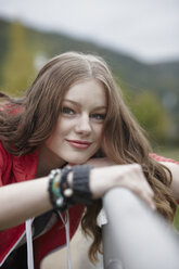 Portrait of teenage girl leaning on a railing - RORF01828