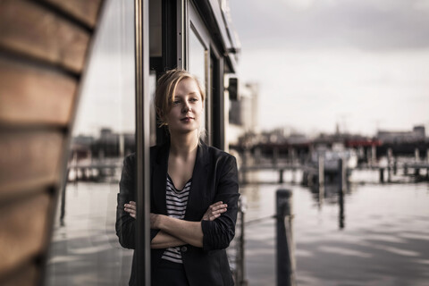 Woman leaning in window of a houseboat, taking a break stock photo