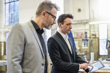 Two businessmen with tablet in a factory - DIGF06220