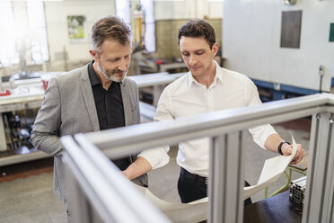 Two businessmen discussing plan in a factory - DIGF06224