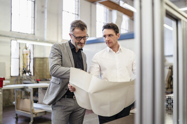 Two businessmen discussing plan in a factory - DIGF06226