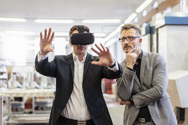 Two businessmen with VR glasses in factory - DIGF06270