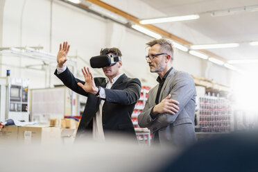 Two businessmen with VR glasses in factory - DIGF06271