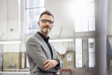 Portrait of confident businessman in factory - DIGF06281