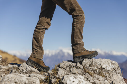 Italy, Como, detail of hiking boots on the rock - MRAF00394