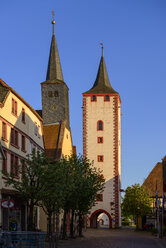 Germany, Bavaria, Franconia, Lower Franconia, Karlstadt am Main, hospital church and gate tower in sunset - LBF02471