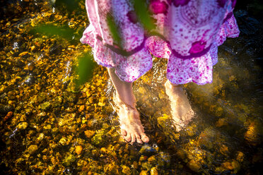 Feet of girl standing in a brook - SARF04178