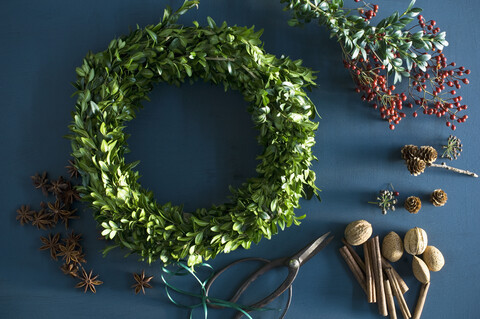 Selfmade Advent wreath, box twigs, rosehip, star anise, cinnamon sticks, walnuts and almonds stock photo