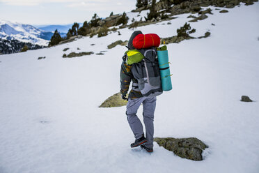 Rear view of man with backpack, snowcapped mountains - ACPF00500